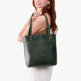 Evergreen Medium Classic | Model wearing leather tote bag with riveted straps and exterior key loop