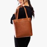 Honey Medium Classic | Model wearing leather tote bag with riveted straps and exterior key loop