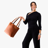 Honey Medium Classic | Model wearing leather tote bag with riveted straps and exterior key loop