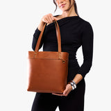 Honey Medium Classic | Model wearing leather tote bag with riveted straps and exterior key loop