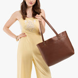 Asheville Large Classic | Model wearing leather tote bag with riveted straps and exterior key loop