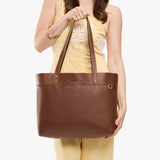 Asheville Large Classic | Model wearing leather tote bag with riveted straps and exterior key loop