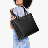 Pebbled--black Large Classic | Model wearing leather tote bag with riveted straps and exterior key loop