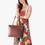 Cognac Large Zipper | Model wearing leather tote bag with riveted straps and exterior key loop