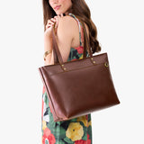 Cognac Large Zipper| Model wearing leather tote bag with riveted straps and exterior key loop
