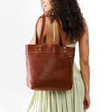 Nutmeg Medium Classic | Model wearing leather tote bag with riveted straps and exterior key loop