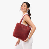 Phoenix Medium Classic | Model wearing leather tote bag with riveted straps and exterior key loop