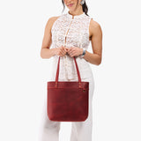 Phoenix Medium Classic | Model wearing leather tote bag with riveted straps and exterior key loop
