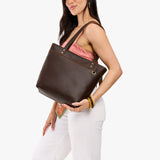 Coldbrew Medium Zipper | Model wearing leather tote bag with riveted straps and exterior key loop