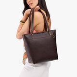 Coldbrew Medium Zipper | Model wearing leather tote bag with riveted straps and exterior key loop