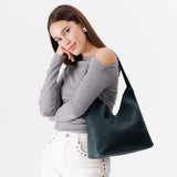 Boreal Large | Model wearing mid-size shoulder bag with magnetic snap closure