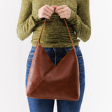 Nutmeg Large | Model holding mid-size shoulder bag with magnetic snap closure
