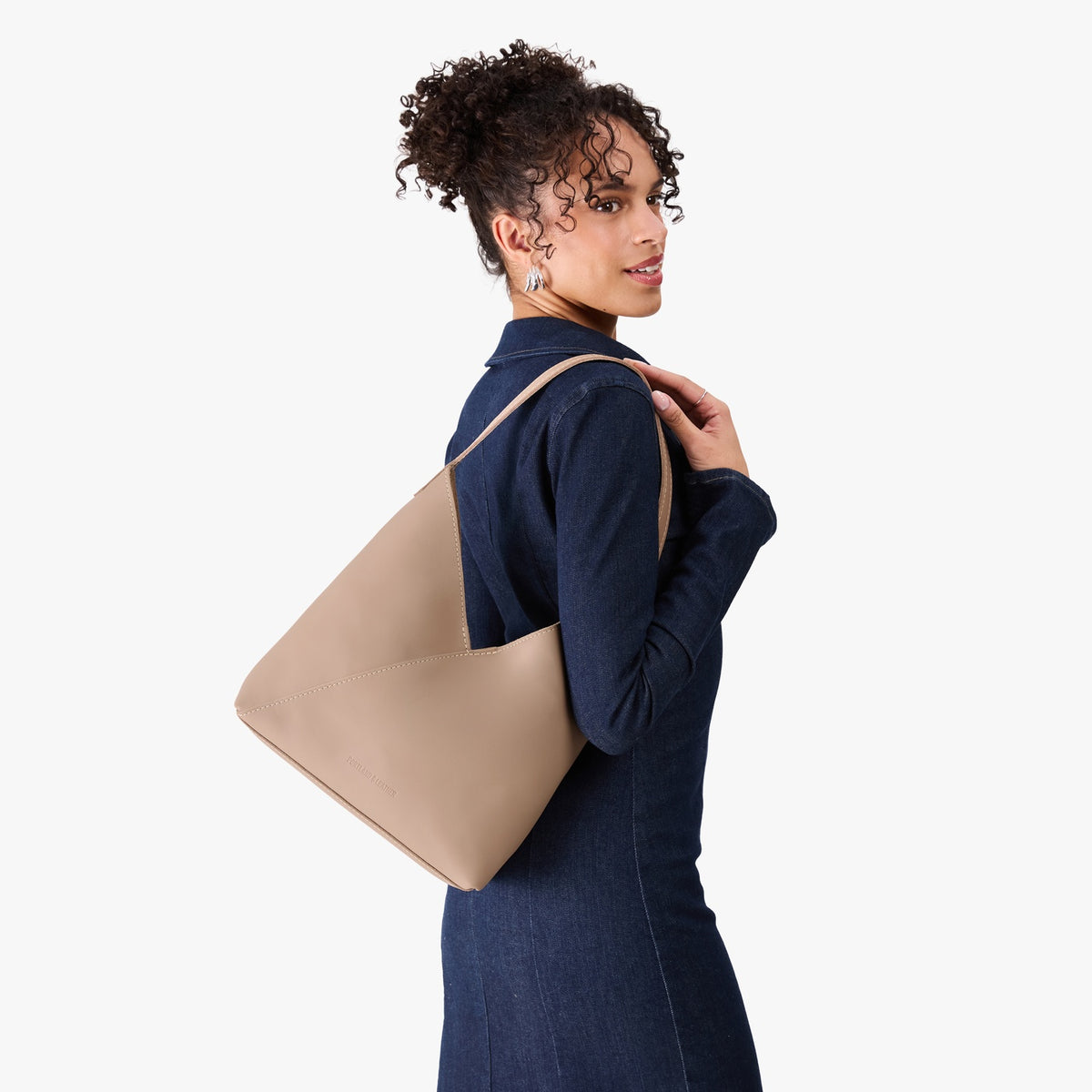Stone*Large | Model wearing mid-size shoulder bag with magnetic snap 
