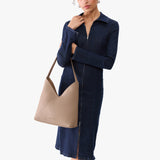 Stone Large | Model wearing mid-size shoulder bag with magnetic snap 