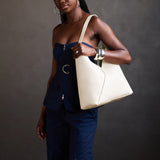 Pebbled Bone Oversized | Model carrying a large shoulder bag with magnetic snap closure