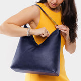 Cobalt Oversized | Model wearing large shoulder bag with magnetic snap closure