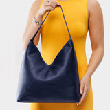 Cobalt Oversized | Model wearing large shoulder bag with magnetic snap closure