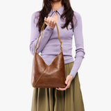 petite shoulder bag with adjustable strap and magnetic snap closure