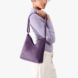 Empire Small | Model wearing petite shoulder bag with adjustable strap and magnetic snap closure