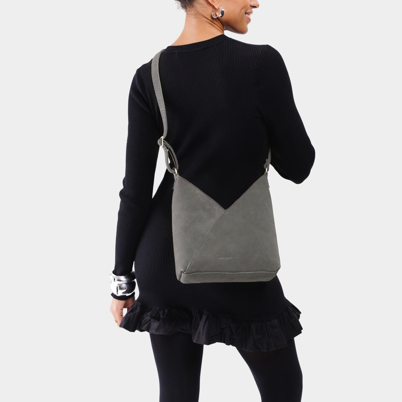 Smoke Grey*Small | Model wearing petite shoulder bag with adjustable strap and magnetic snap closure