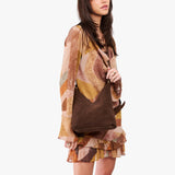 Stagecoach Small | Model wearing petite shoulder bag with adjustable strap and magnetic snap closure