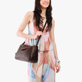 Coldbrew Medium | Model wearing a leather Crossbody with a flap and magnetic closure