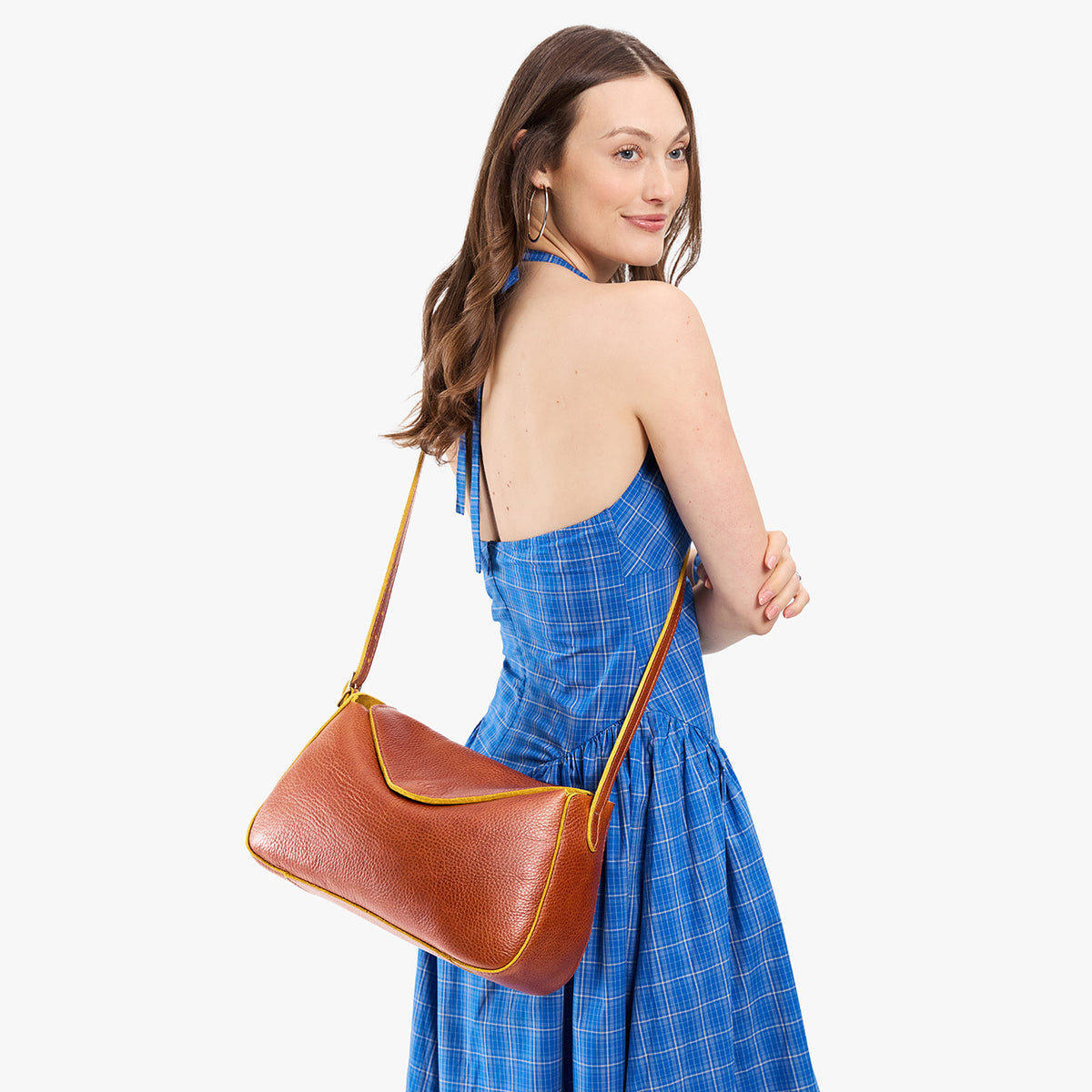 Sienna*Medium | Model wearing a leather Crossbody with a flap and magnetic closure