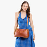 Sienna Medium | Model wearing a leather Crossbody with a flap and magnetic closure