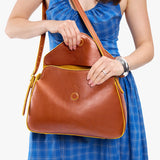 Sienna Medium | Model wearing a leather Crossbody with a flap and magnetic closure