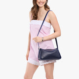 Cobalt Small | Model wearing a leather Crossbody with a flap and magnetic closure