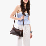 Coldbrew Small | Model wearing a leather Crossbody with a flap and magnetic closure