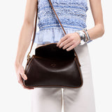 Coldbrew Small | Model wearing a leather Crossbody with a flap and magnetic closure