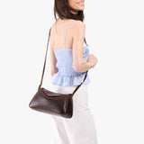 Coldbrew Small | Model wearing a leather Crossbody with a flap and magnetic closure