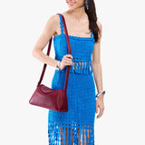 Orchid Small | Model wearing a leather Crossbody with a flap and magnetic closure