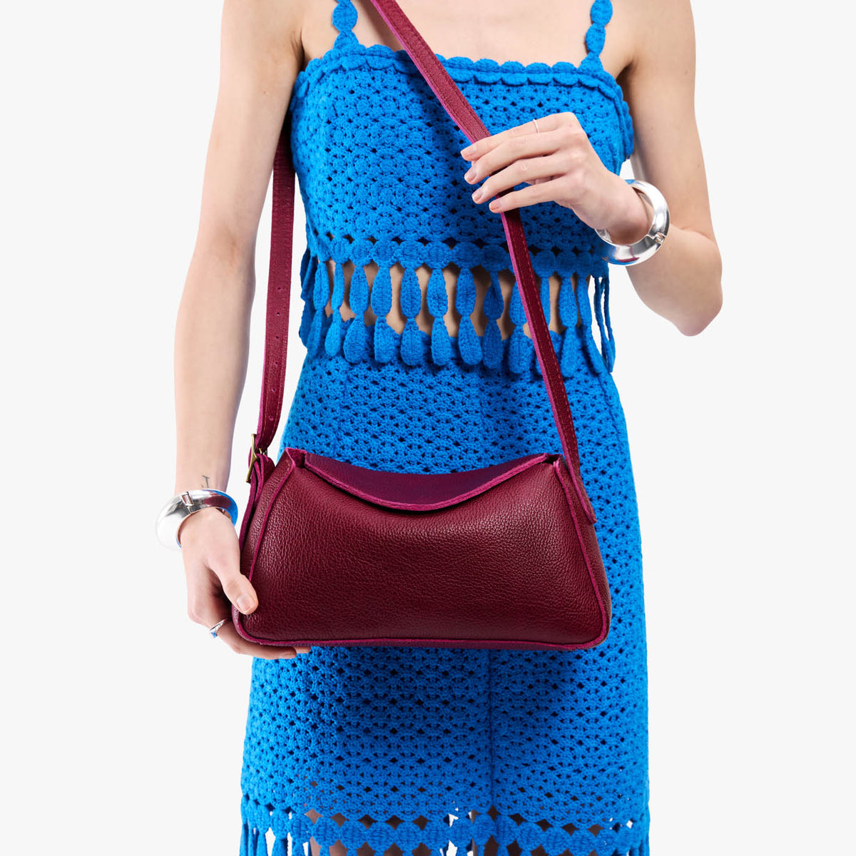 Orchid*Small | Model wearing a leather Crossbody with a flap and magnetic closure