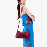 Orchid Small | Model wearing a leather Crossbody with a flap and magnetic closure