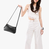 Pebbled--black Small | Model wearing a leather Crossbody with a flap and magnetic closure