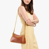 Sienna Small | Model wearing a leather Crossbody with a flap and magnetic closure