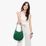 Bacalar Medium | Model holding round leather purse with adjustable shoulder strap