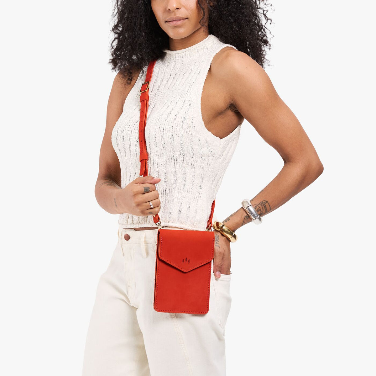 Paprika | Model carrying slim, phone-shaped crossbody purse with magnetic closure