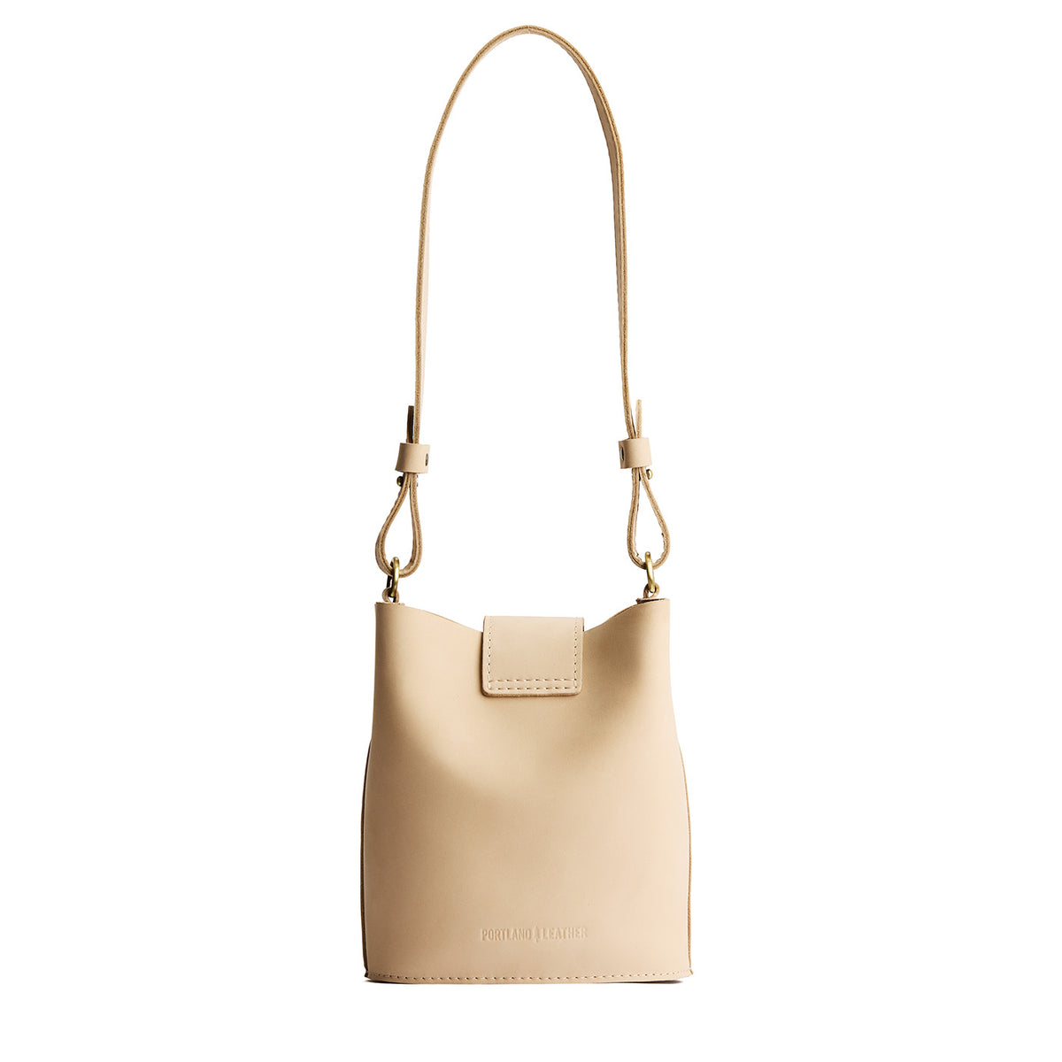 Dragon Bone | Leather bucket shoulder bag with adjustable strap and magnetic closure on a white background