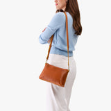 Sienna Small | Model wearing a zip top crossbody bag with detachable strap