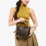 Grizzly Small | Model holding petite tote purse with structured leather handles and crossbody strap
