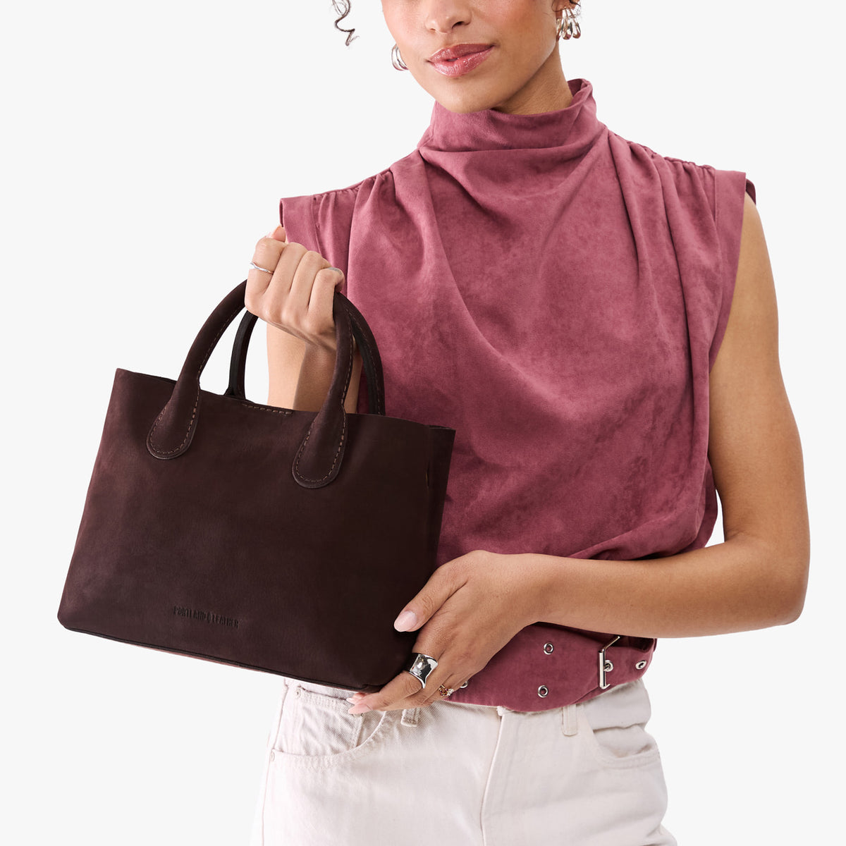 Velvet Brown*Large | Model holding mid-size tote purse with  structured leather handles and crossbody strap