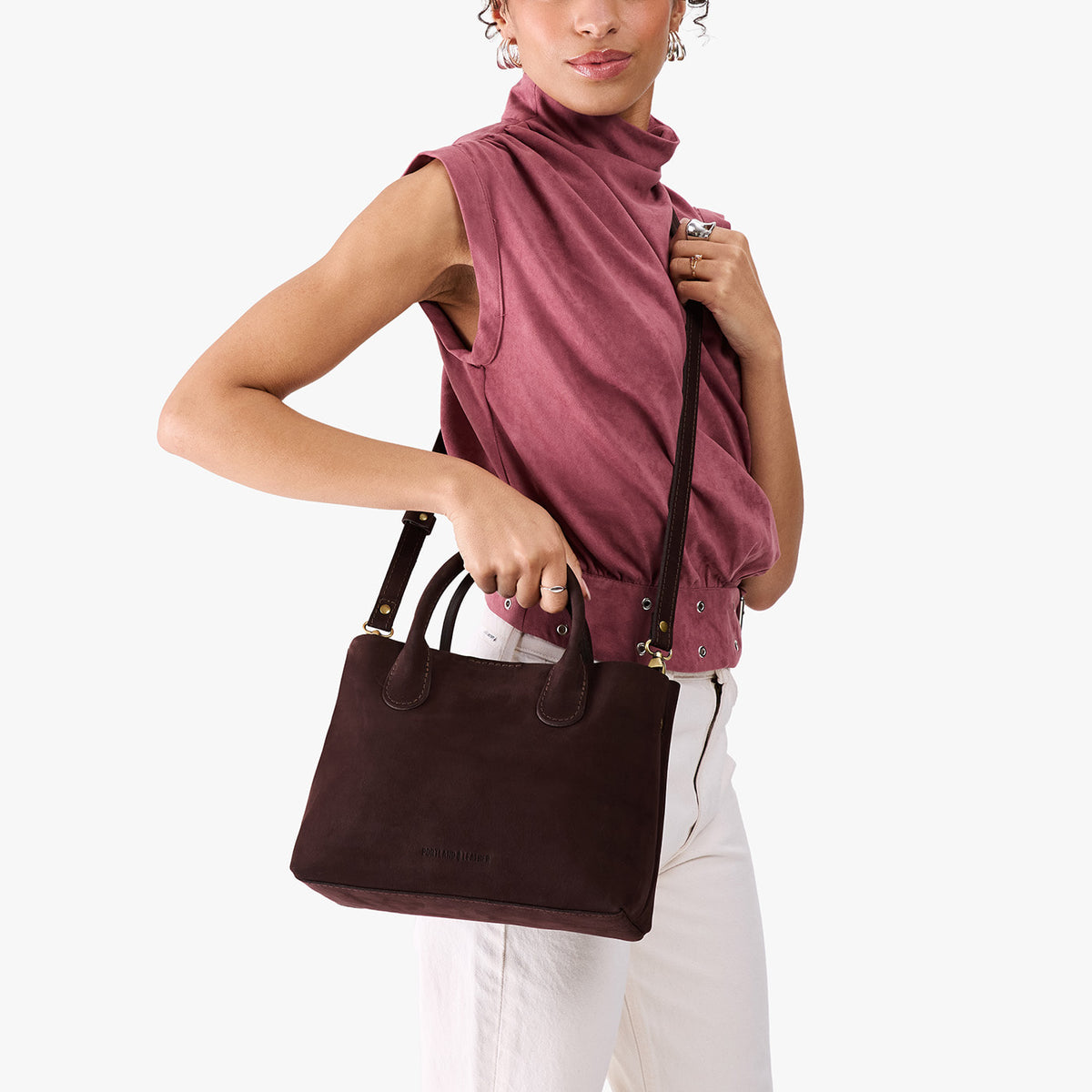 Velvet Brown*Large | Model holding mid-size tote purse with  structured leather handles and crossbody strap