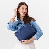 Deep Water Large | Model holding mid-size tote purse with  structured leather handles and crossbody strap