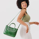 Cowboy Mint Large | Model holding mid-size tote purse with  structured leather handles and crossbody strap