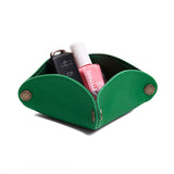 Jolly Green | Square-shaped foldable leather tray with snap-button corners holding nail polish and car keys