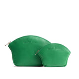 Jolly Green | Comparison shot of small and large seashell shaped leather makeup bags with curved top zipper and flat bottom