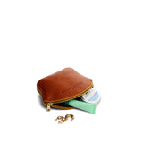 Sienna Small | Seashell shaped leather makeup bag with curved top zipper and flat bottom